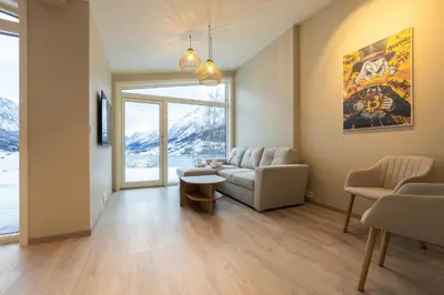 a living room with a couch and a table at Leilighet med utsikt i Loen in Stryn