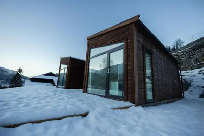 a small house in the snow in the snow at Leilighet med utsikt i Loen in Stryn
