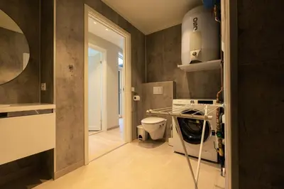 a kitchen with a washer and dryer in a room at Leilighet med utsikt i Loen in Stryn