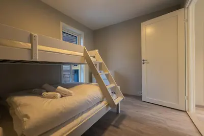 a bedroom with a bunk bed with a ladder at Leilighet med utsikt i Loen in Stryn