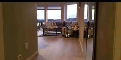 a living room with a couch and a table at Fjordcabin Panoramic view Near Bergen 3 sleepingroom in Forland