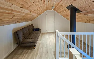 a living room with a couch and a staircase at Gorgeous Home In Rauland With Kitchen in Rauland