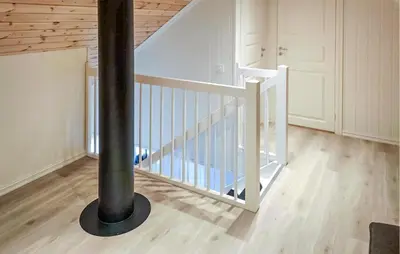 a white staircase with a black pole in a room at Gorgeous Home In Rauland With Kitchen in Rauland