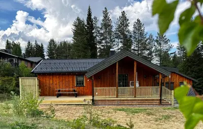 a log cabin with a picnic table in front of it at Trysil Moderna Lodge in Trysil