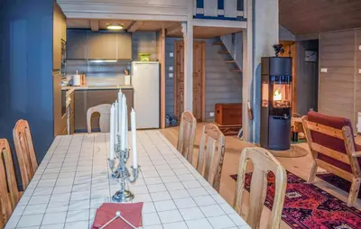 a kitchen and dining room with a table and a refrigerator at Lovely Home In Geilo With Wifi in Geilo