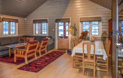 a dining room and living room with a table and chairs at Lovely Home In Geilo With Wifi in Geilo
