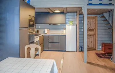 a kitchen with a refrigerator and a table in a room at Lovely Home In Geilo With Wifi in Geilo