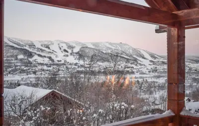 a view of a snowy mountain from a cabin window at Lovely Home In Geilo With Wifi in Geilo