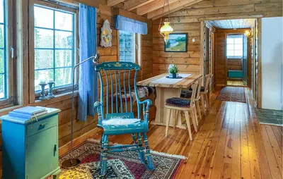 a room with a rocking chair and a table in a cabin at Lovely Home In Stranda With Wifi in Stranda