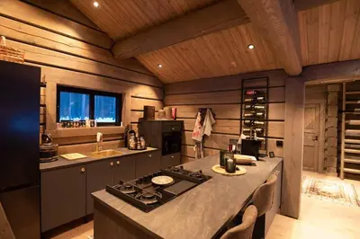 a kitchen with a stove and a counter top at ElveRo Lodge in Trysil