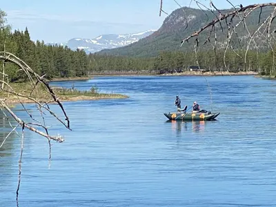 two people in a boat on a lake at ElveRo Lodge in Trysil