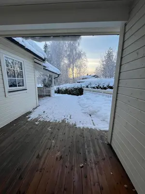 an open garage door with snow on a house at Stue, soverom og bad in Åmot