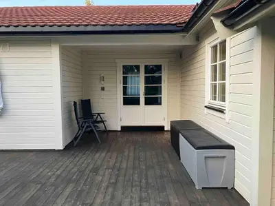 a porch of a house with a bench on a deck at Stue, soverom og bad in Åmot