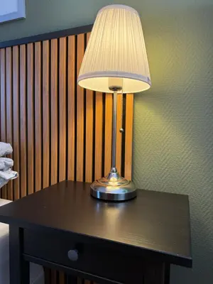 a table with a lamp on top of it at Stue, soverom og bad in Åmot