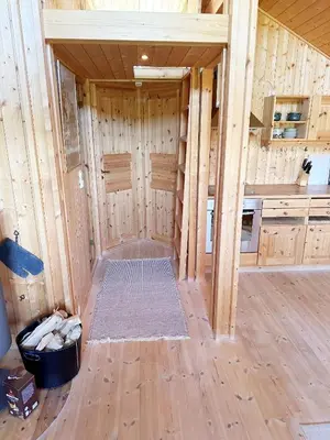 an inside view of a kitchen with wooden walls at Kinnkosen - cabin with panoramic view for 6 persons in Ål