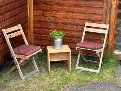 two chairs and a table with a potted plant on it at Kinnkosen - cabin with panoramic view for 6 persons in Ål