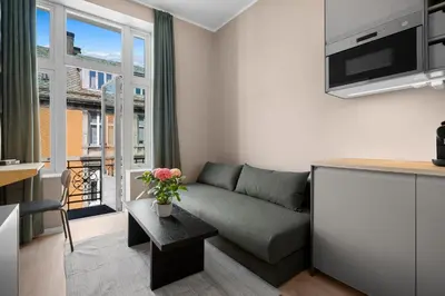 a living room with a couch and a large window at Bohemian Hotel - Self-Service in Bergen