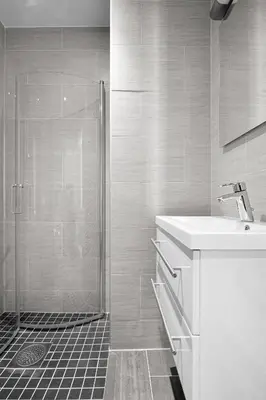 a white bathroom with a shower and a sink at Bohemian Hotel - Self-Service in Bergen