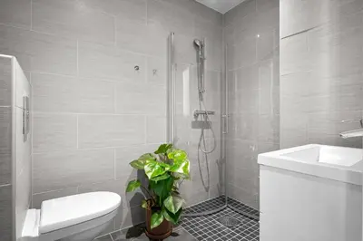 a bathroom with a shower and a toilet and a sink at Bohemian Hotel - Self-Service in Bergen