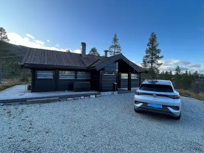 a truck parked in front of a house at Hito - cabin between Flå and Eggedal in Flå