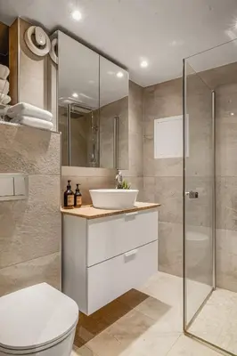 a bathroom with a sink and a toilet and a shower at Bryggen Hideaway I Lux Feeling & Private Patio in Bergen