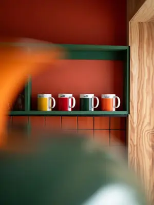 a row of coffee mugs sitting on a shelf at Unique Studio I Custom Built I 500 Meters From Bryggen in Bergen