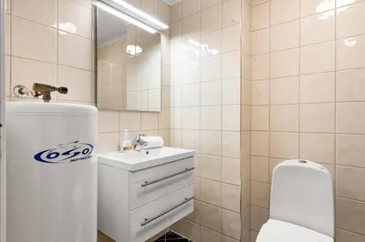 a bathroom with a toilet and a sink and a mirror at Unique Studio I Custom Built I 500 Meters From Bryggen in Bergen
