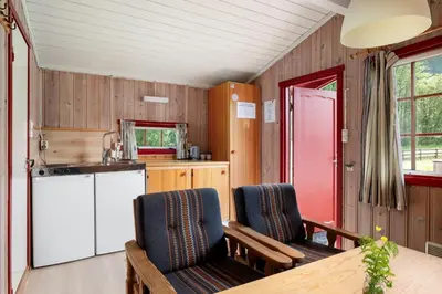 a kitchen with two chairs and a table in a room at Utladalen Camping in Årdal