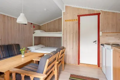 a kitchen and dining room with a table and chairs at Utladalen Camping in Årdal