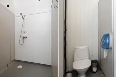 a white bathroom with a toilet and a shower at Utladalen Camping in Årdal