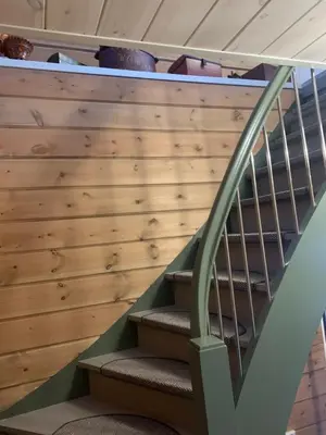 a staircase in a house with a wooden wall at Villa Flo in Stryn