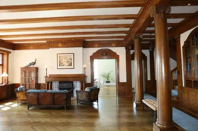 a living room with a wooden ceiling and a grand piano at Luxury Historic Villa with private coastline in Bergen