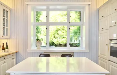 a kitchen with a white counter and a window at Luxury Historic Villa with private coastline in Bergen