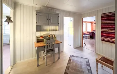 a kitchen with a table and a chair in a room at Amazing Home In Svingvoll in Svingvoll