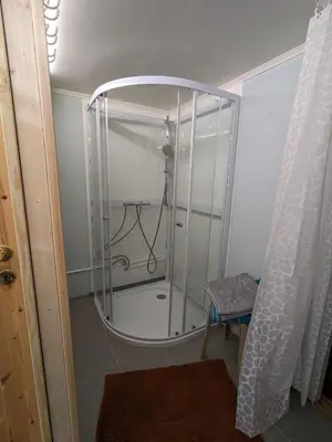 a shower with a glass enclosure in a bathroom at Overnatting Rodal in Valsøybotn
