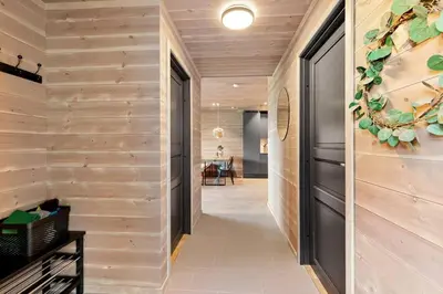 a hallway of a house with wooden walls at Leilighet - Panorama view - Sogndal Skisenter Hodlekve in Sogndal