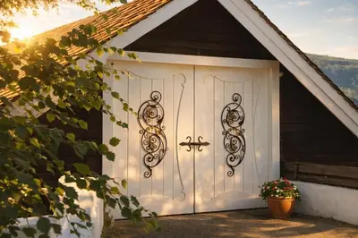 a white garage door with a cross on it at Sjarmerende tømmerhytte på gårdstun in Baukål
