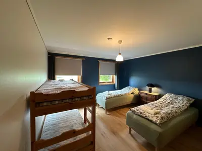 two beds in a room with blue walls at Lovely fully furnished apartment in Ottestad