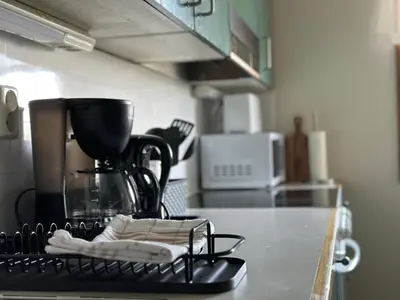 a kitchen counter with a coffee maker on a counter top at Lovely fully furnished apartment in Ottestad