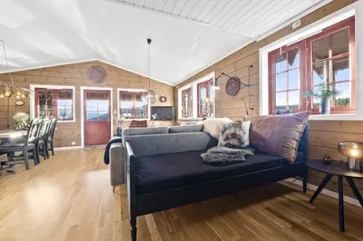 a living room with a blue couch and a table at Hytte Stryn skisenter in Stryn