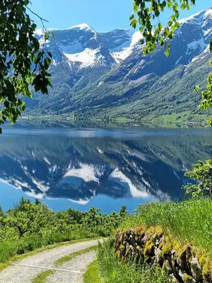 a view of a lake with snow capped mountains at Flo Bellevue in Stryn