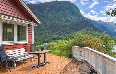 a deck with a bench and a table on a house at Lovely Home In Bjordal With Kitchen in Bjordal