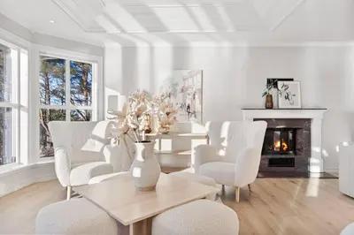 a living room with a table and chairs and a fireplace at Waterfront Villa w/Boat&kayaks. 15min from Bergen in Foldnes