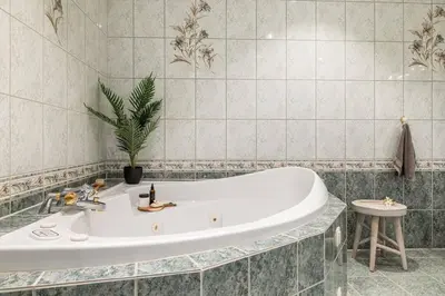 a bath tub in a bathroom with a potted plant at Waterfront Villa w/Boat&kayaks. 15min from Bergen in Foldnes