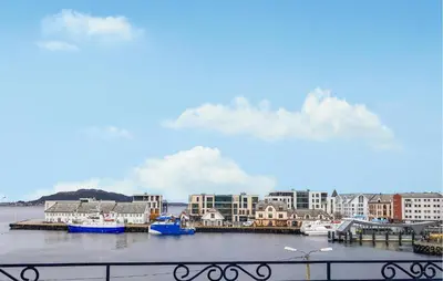 a group of boats are docked in a harbor at 1 Bedroom Stunning Apartment In Ålesund in Ålesund