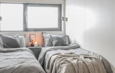 two beds sitting next to each other in a bedroom at Gorgeous Home In Bjorli With Wifi in Bjorli