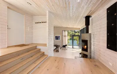 a living room with a fireplace and wooden floors at 4 Bedroom Lovely Home In Skodje in Skodje