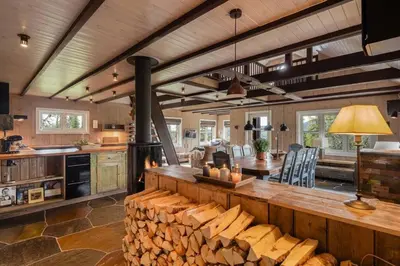 a large kitchen with a wood stove in it at Your Ideal Getaway Awaits in This Charming Cabin Retreat in Nord Torpa