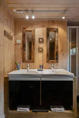 a bathroom with a large sink and two mirrors at Your Ideal Getaway Awaits in This Charming Cabin Retreat in Nord Torpa