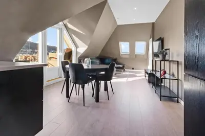 a kitchen and dining room with a table and chairs at Penthouse apartment in Bergen in Bergen